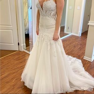 Brand new wedding gown never worn still in bag.